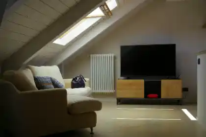 a living room with a tv and couches